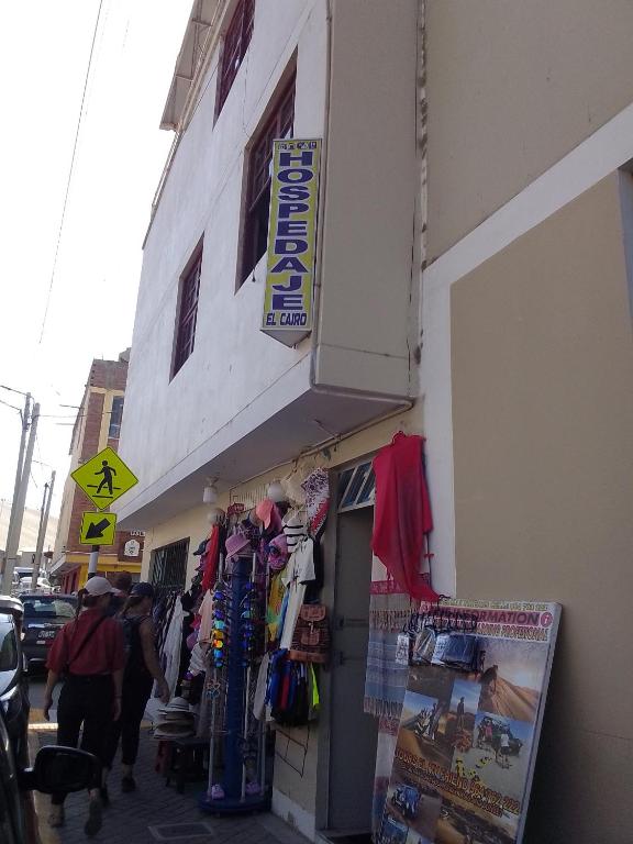 a store with a sign on the side of a building at Hospedaje El Cairo in Ica
