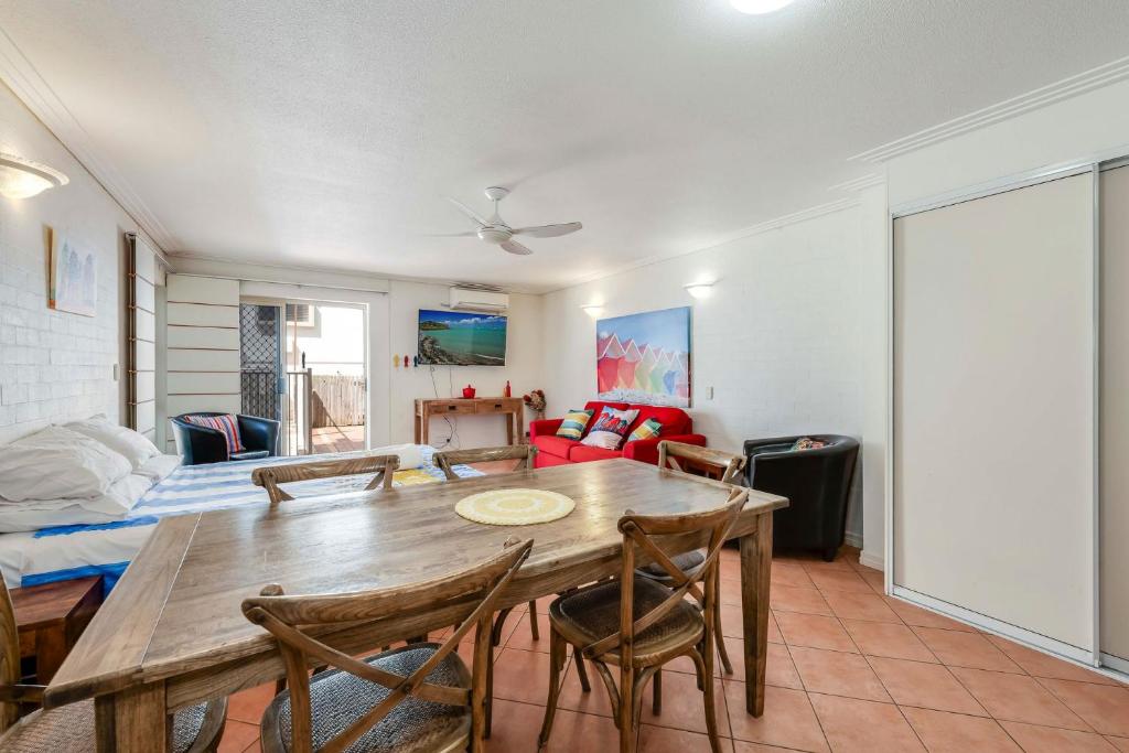 a living room with a wooden table and chairs at Shoreline Apartments - Unit 9a in Bargara