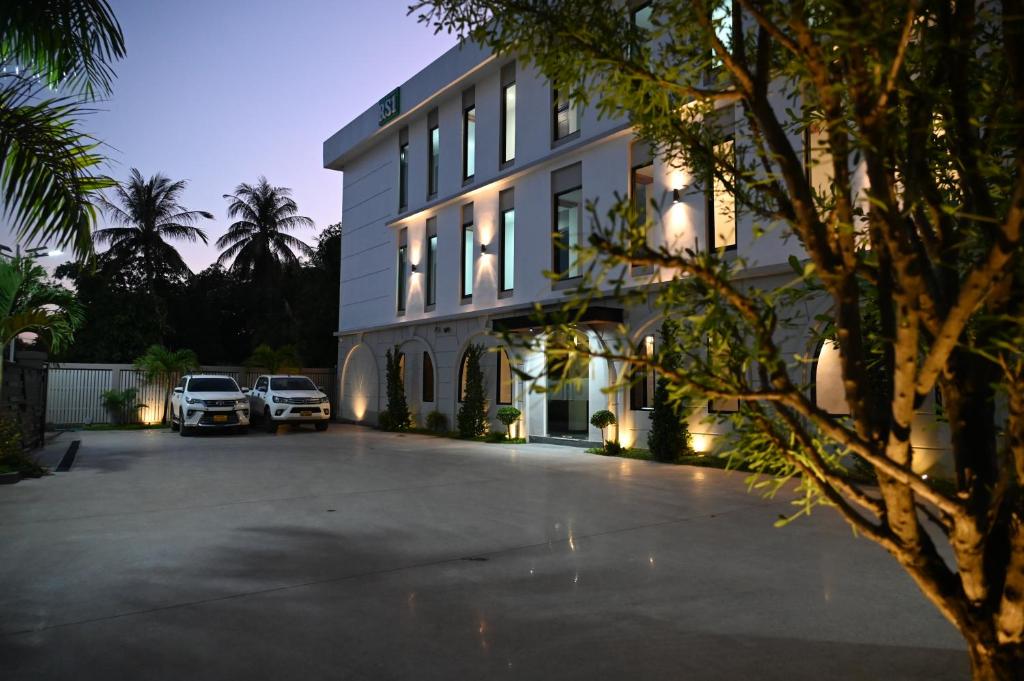 Ban Pho TouaneRS1 Hotel的两辆车停在停车场的大楼