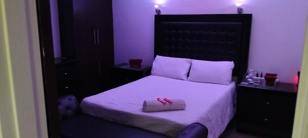 a bed with a pair of red shoes sitting on it at Diamondfield trading guesthouse in Kimberley