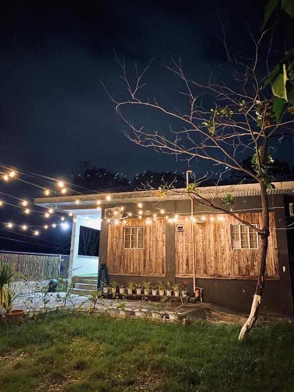 a house with lights on it at night at Hidden Leaf Villa in Caoayan