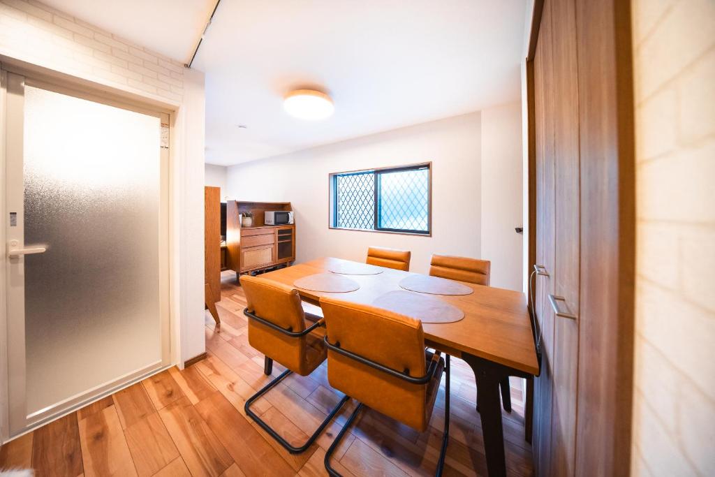 a dining room with a table and chairs at Private House KANADE in Nara