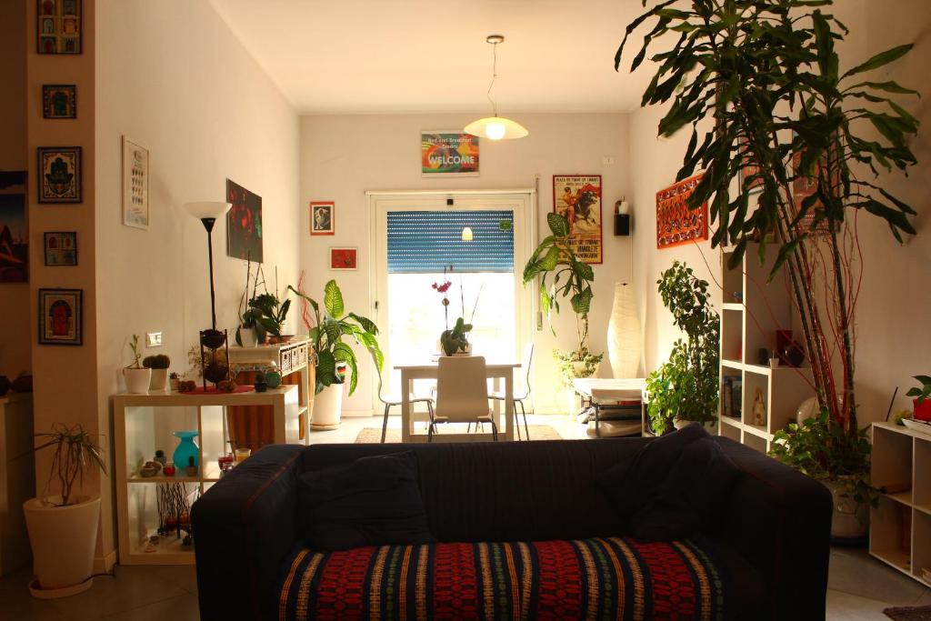a living room with a couch and a table with plants at Esedra B&B in Palermo