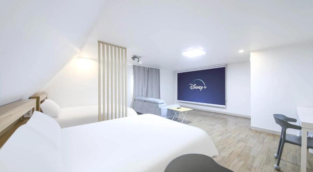 a hotel room with a bed and a projection screen at The Oakra Hotel in Jeju