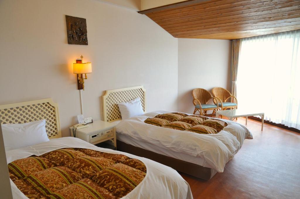 Postel nebo postele na pokoji v ubytování Tateyama Resort Hotel