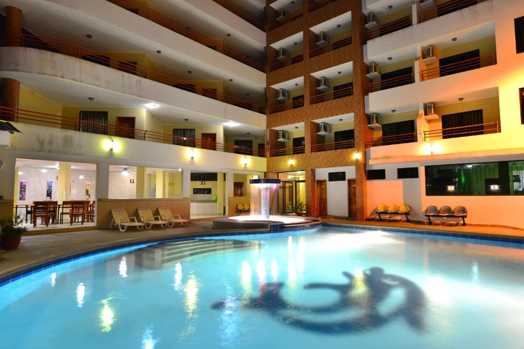 a large swimming pool in a hotel lobby at Hotel La Aldea in Atacames