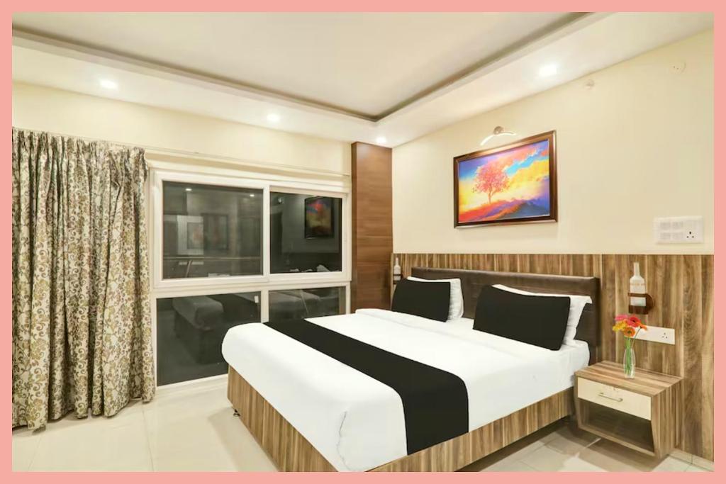 Un dormitorio con una cama grande y una ventana. en Rajshekhar PVS - Grand Premium Near Vishwanath Temple -Luxury And Spacious Rooms -Wifi #Parking #Lift - BEST HOTEL, en Varanasi