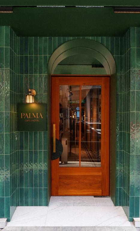 an entrance to a building with a wooden door at Palma Hotel in Bangkok