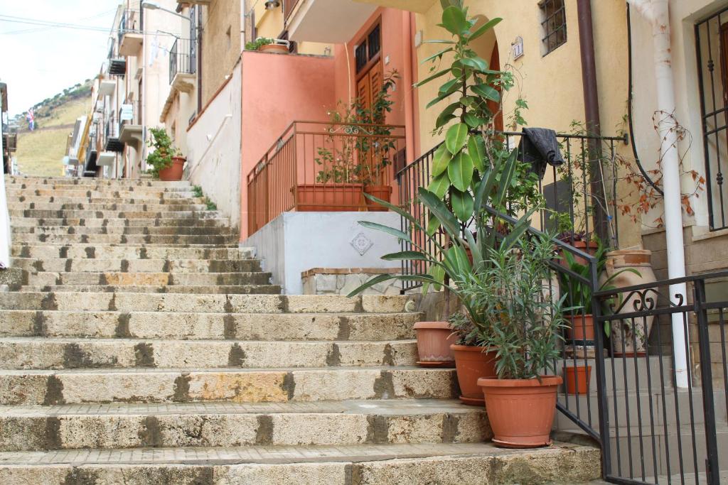 a set of stairs with potted plants on them at Soleluna in Castellammare del Golfo