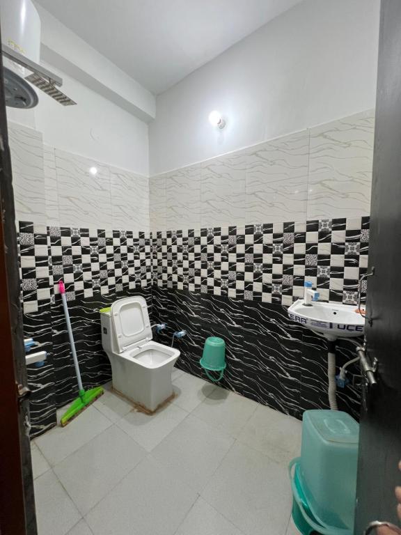 a bathroom with a toilet and a sink at Kamal kishori Dham Guest house in Barsāna