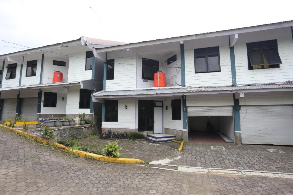 a large white building with a street in front of it at Villa Gunung By ARBA in Pasakon 1