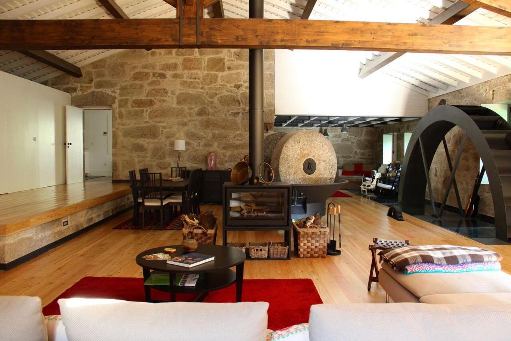 a large living room with a stone wall at Moinho do Ázere in Arcos de Valdevez