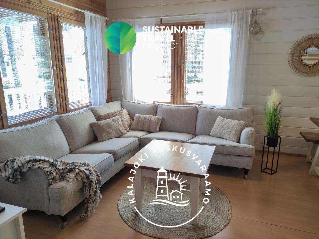 a living room with a couch and a table at Lomasärkkä1 in Kalajoki