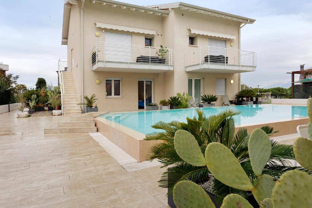 a villa with a swimming pool in front of a house at Albiceleste Prime Location in Peschiera del Garda