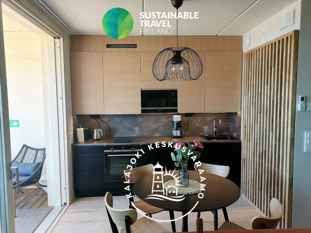 Marina Resort A5 في كالايوكي: مطبخ مع طاولة مع كراسي وغرفة طعام