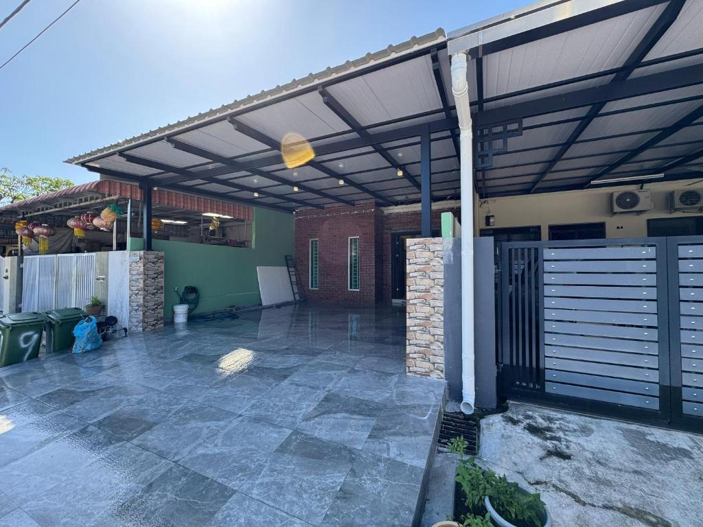 a patio with awning on the side of a house at Spacious Comfort Staycation Homefeel free WIFI TK9 in Ipoh