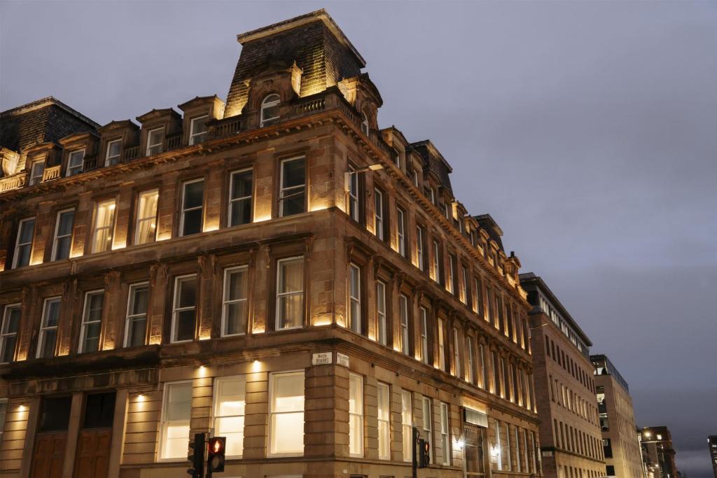 a large building with a clock on top of it at The Wellington Glasgow by Adina in Glasgow