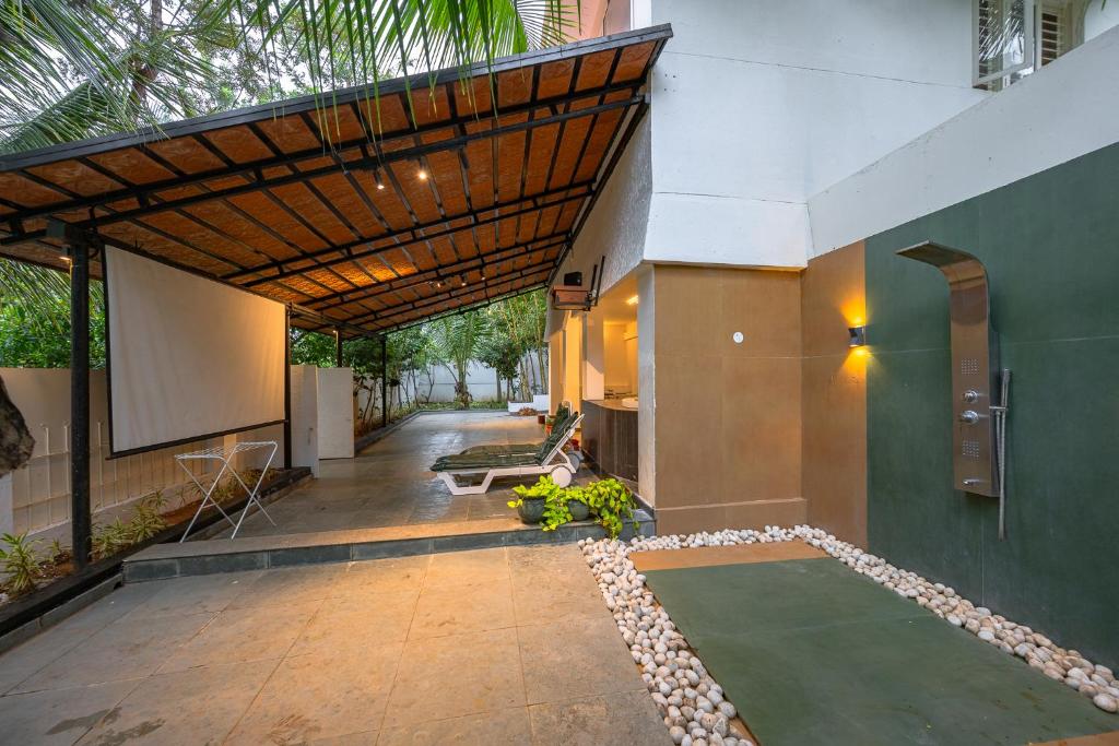 an external view of a house with a green lawn at Bangalore Bubble Stay 1BHK Villa - Bella in Denkanikota