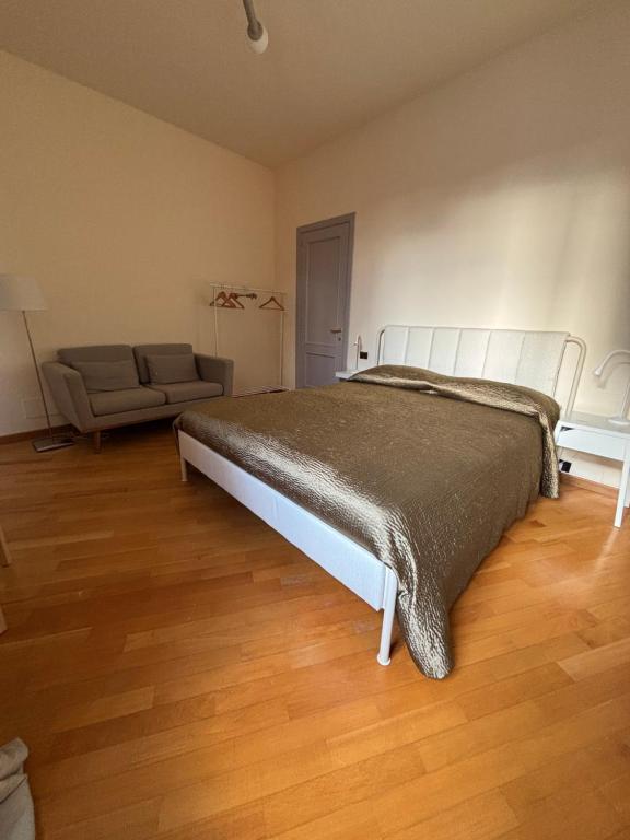 a bedroom with a large bed and a couch at Mater Domini in Chieti