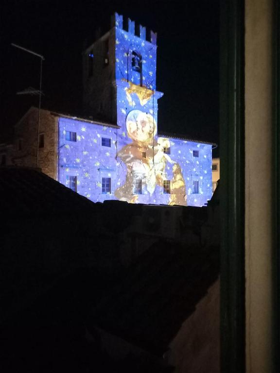 a building with a clock tower with blue lights on it at Raggi di Sole in Cortona