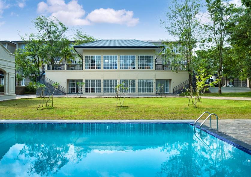 una casa con piscina delante de una casa en The Palace Gampaha by Axendra, en Gampaha