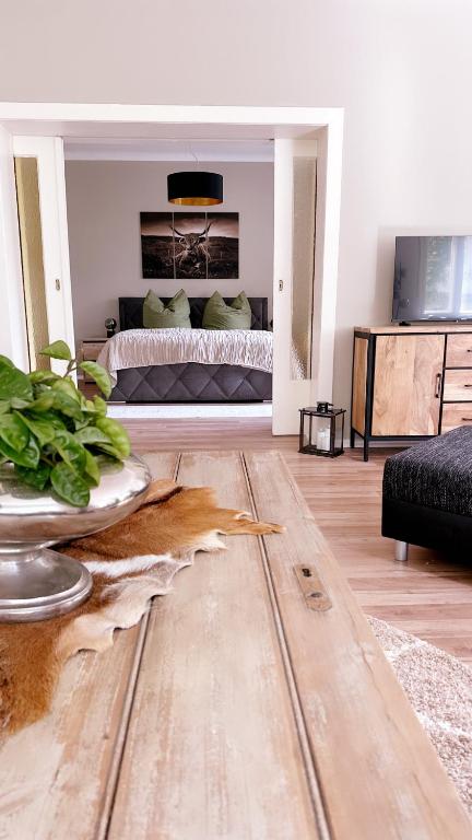 a bedroom with a bed and a wooden floor at Ferienwohnung Seelenruh in Falkensee