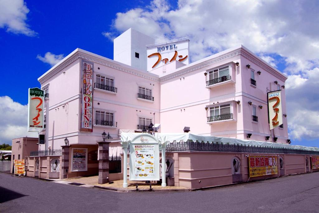 a large white building with a sign in front of it at Hotel Fine Biwako I in Moriyama