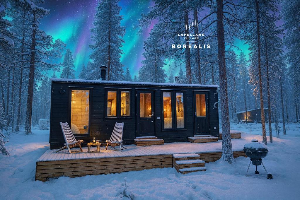 a cabin in the woods with the northern lights at Lapland Landscape Cabin with Nature View, Sauna, Fireplace & Kitchen, Ylläs, Äkäslompolo, Borealis Village in Äkäslompolo