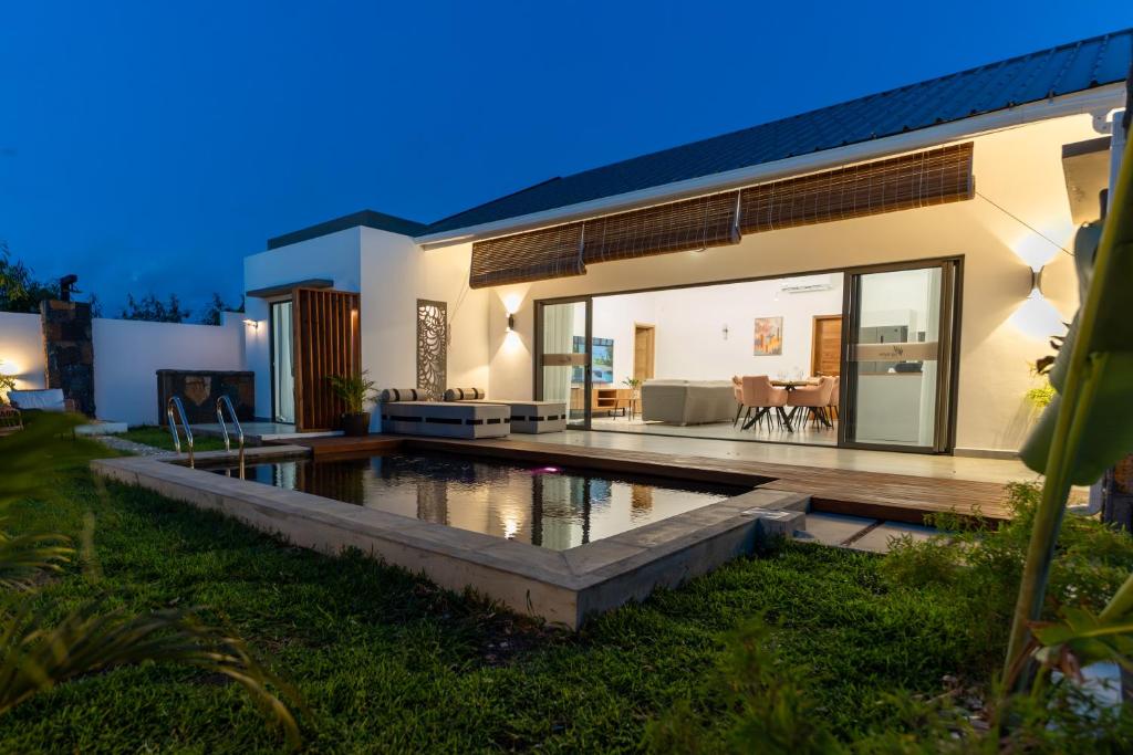 a house with a swimming pool in the yard at Arama Villa by Swarga Mauritius in Cap Malheureux