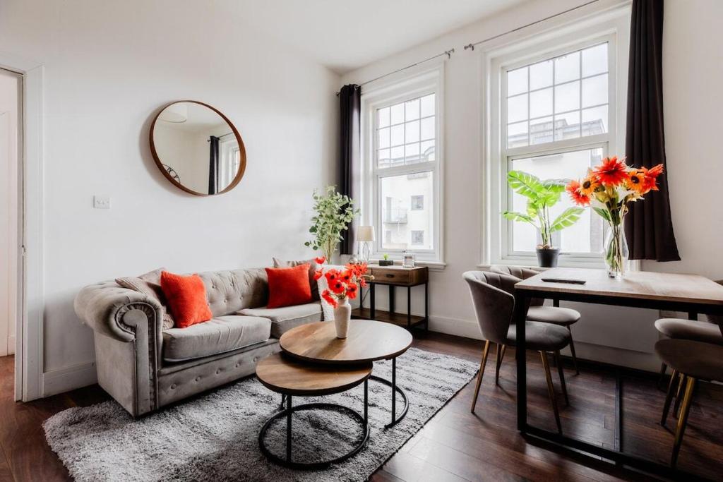 a living room with a couch and a table at The Regency | Seafront Lux Apartments! in Southend-on-Sea