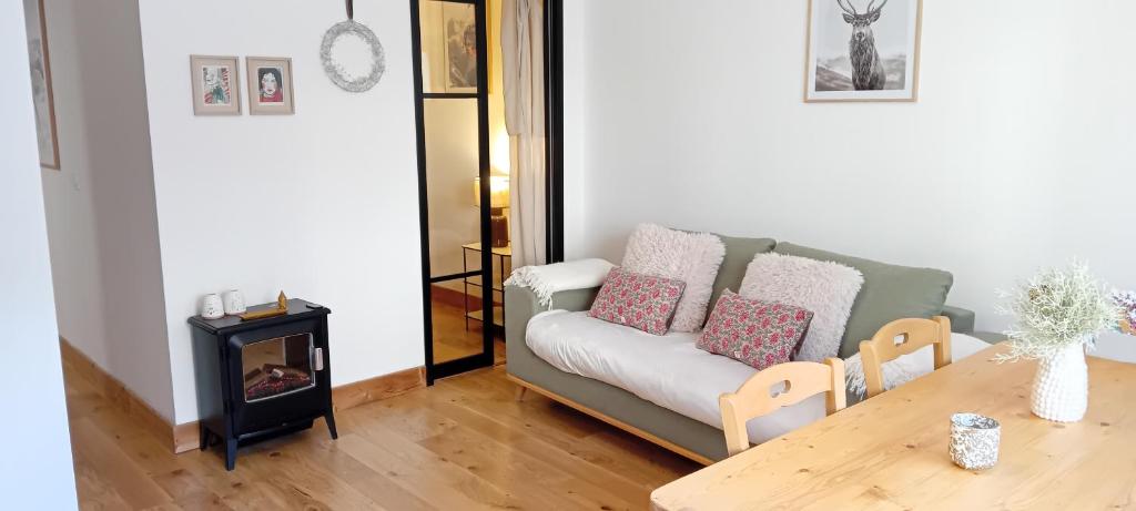 a living room with a couch and a table at Balcons G 013 - PARC NAT VANOISE appart 8 pers in Termignon