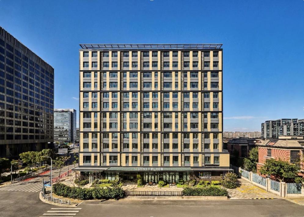 ein hohes weißes Gebäude mit vielen Fenstern in der Unterkunft Hyatt Place Shanghai Lingang in Huinan