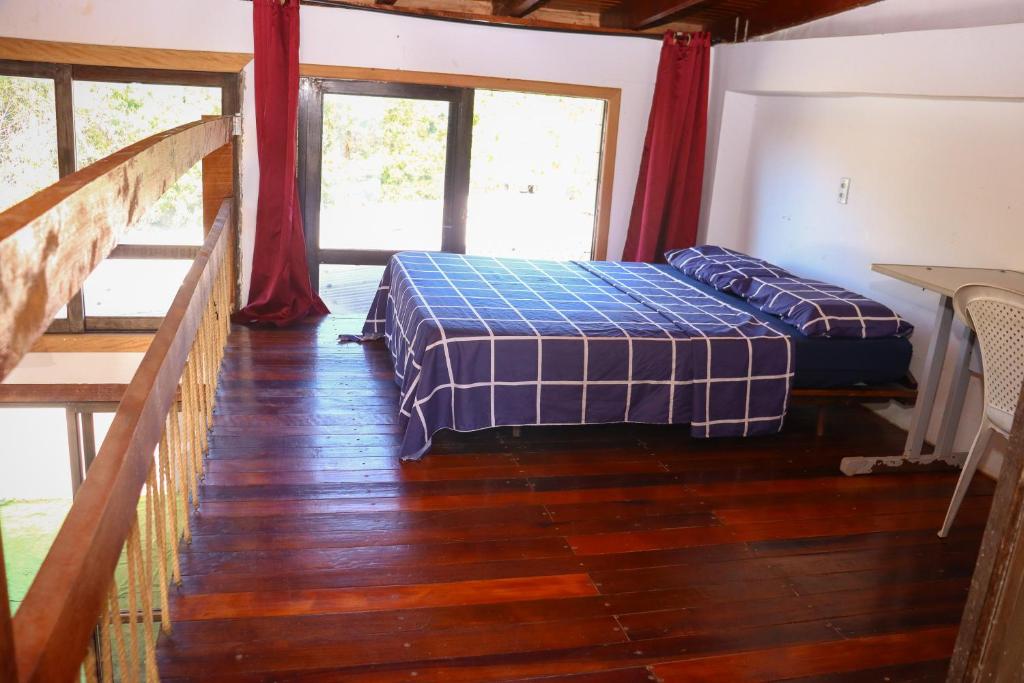 a bedroom in a house with a bed and a staircase at Sobrado São Chico, Ubatuba SFS in São Francisco do Sul