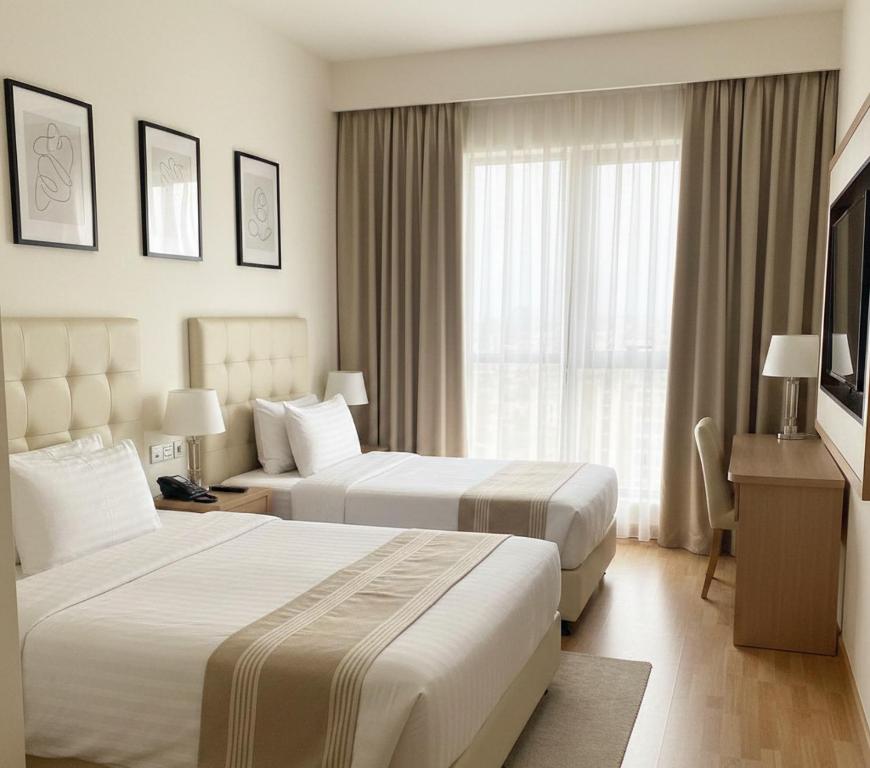 a hotel room with two beds and a window at Görgülü Apart 06 in Mamak