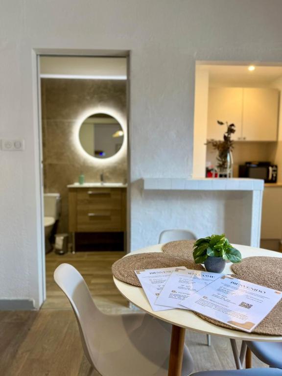 a table and chairs in a room with a kitchen at Studio au cœur de Lourdes in Lourdes