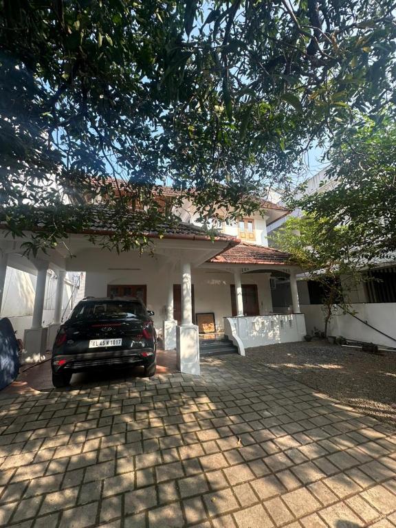 a car parked in front of a house at Ironwood Villa in Cochin