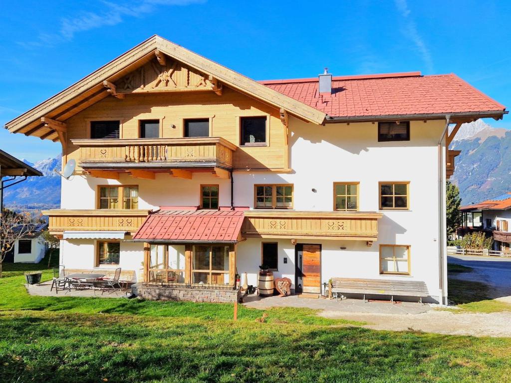 a large house with a red roof at Apartment Wildschütz by Interhome in Weerberg