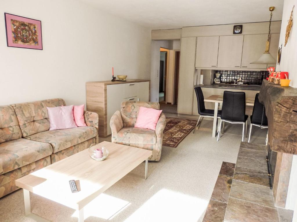 a living room with a couch and a table at Apartment Curnera 9-4 by Interhome in Laax-Murschetg
