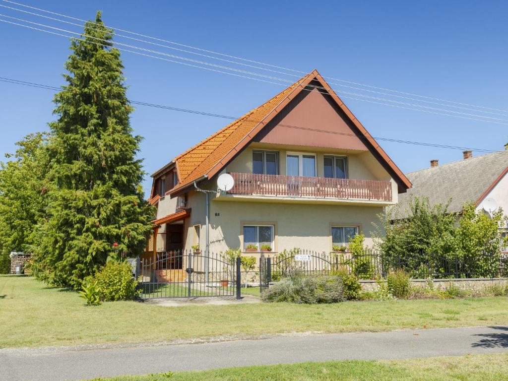 a house with a fence and a tree at Apartment Pajtas 2 by Interhome in Balatonfenyves