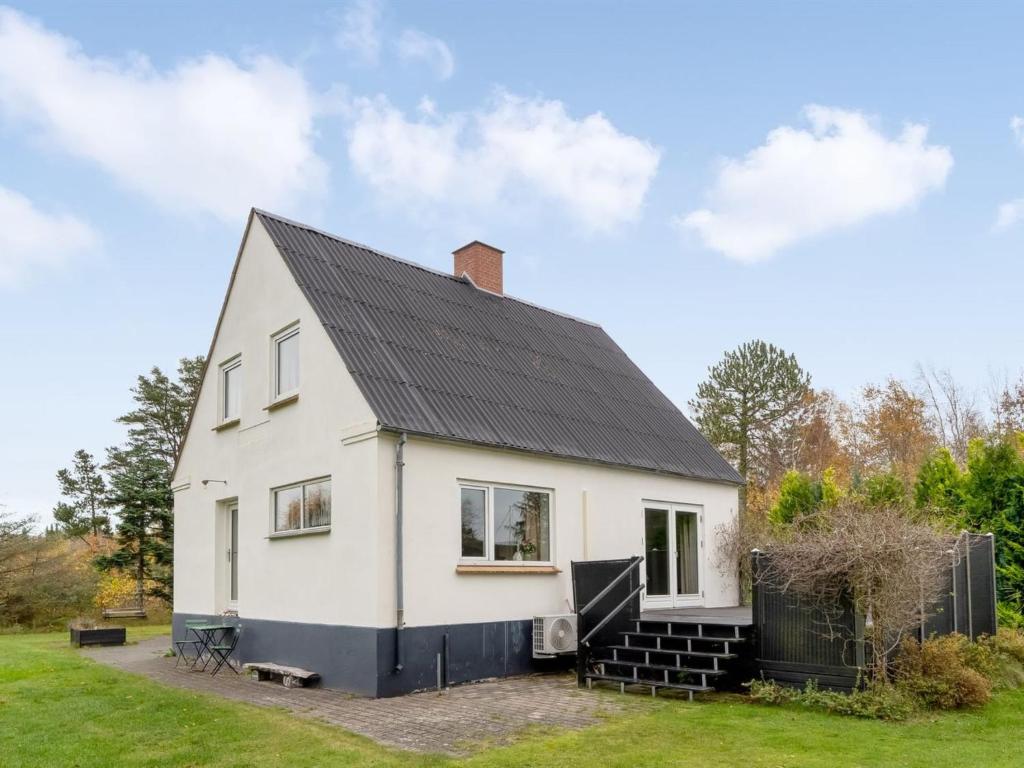 a white house with a black roof at Holiday Home Paule - 1-3km from the sea by Interhome in Vesterø Havn