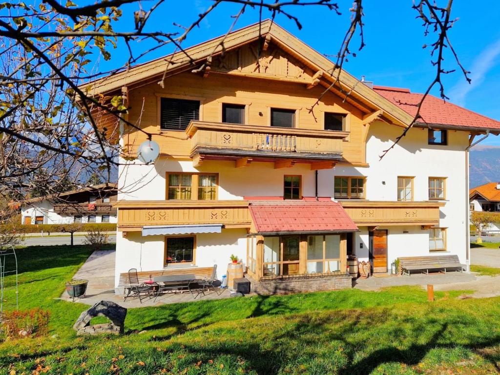 a large house with a red roof at Apartment Almluft by Interhome in Weerberg