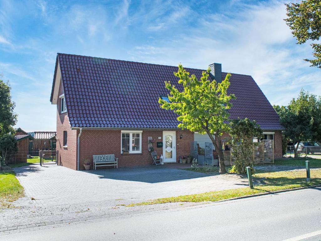 a red brick house with a black roof at Apartment Die Dorfperle by Interhome in Wanna