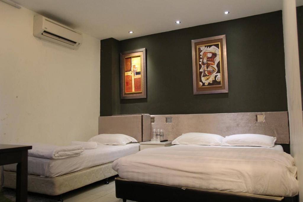Postel nebo postele na pokoji v ubytování M Design Hotel @ Seri Kembangan