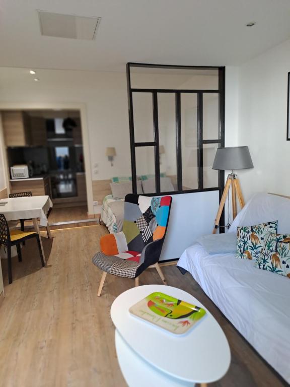 a living room with a couch and a table at Le studio d' EMI in Argelès-Gazost