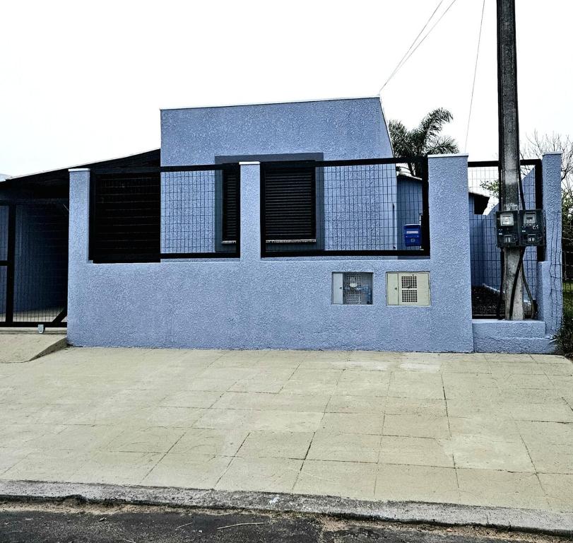 a blue building with a parking meter in front of it at Casa 264 in Capão da Canoa