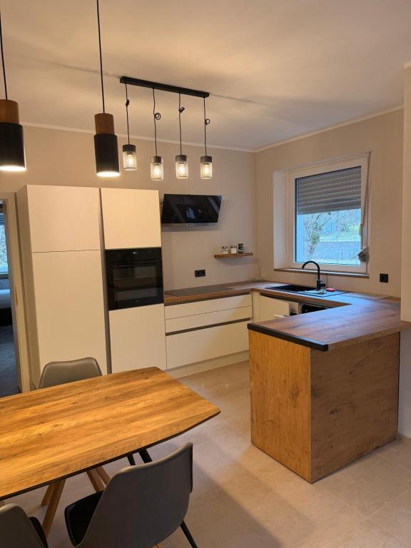 a kitchen with a wooden table and a counter top at LevelUp 5von5 in Koblenz