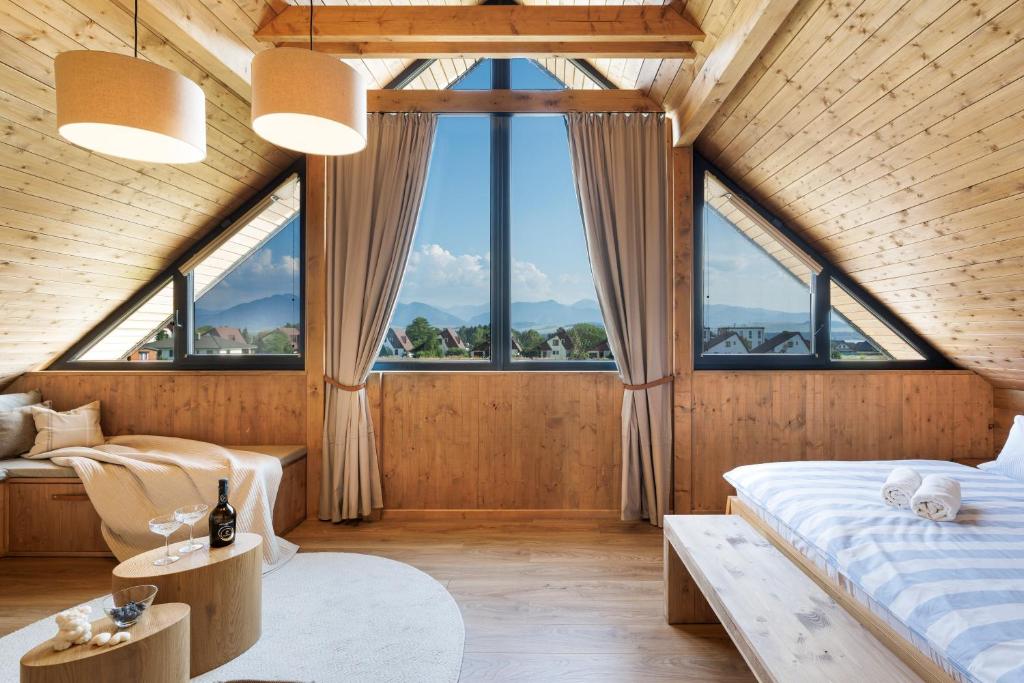 1 dormitorio con 2 camas y ventanas grandes en Liptovské Chaty, en Liptovský Mikuláš