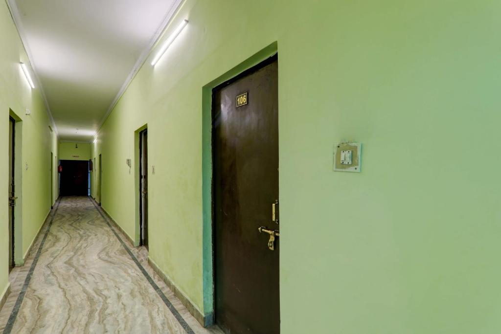 an empty corridor with a door in a building at AV Hotels in Lucknow