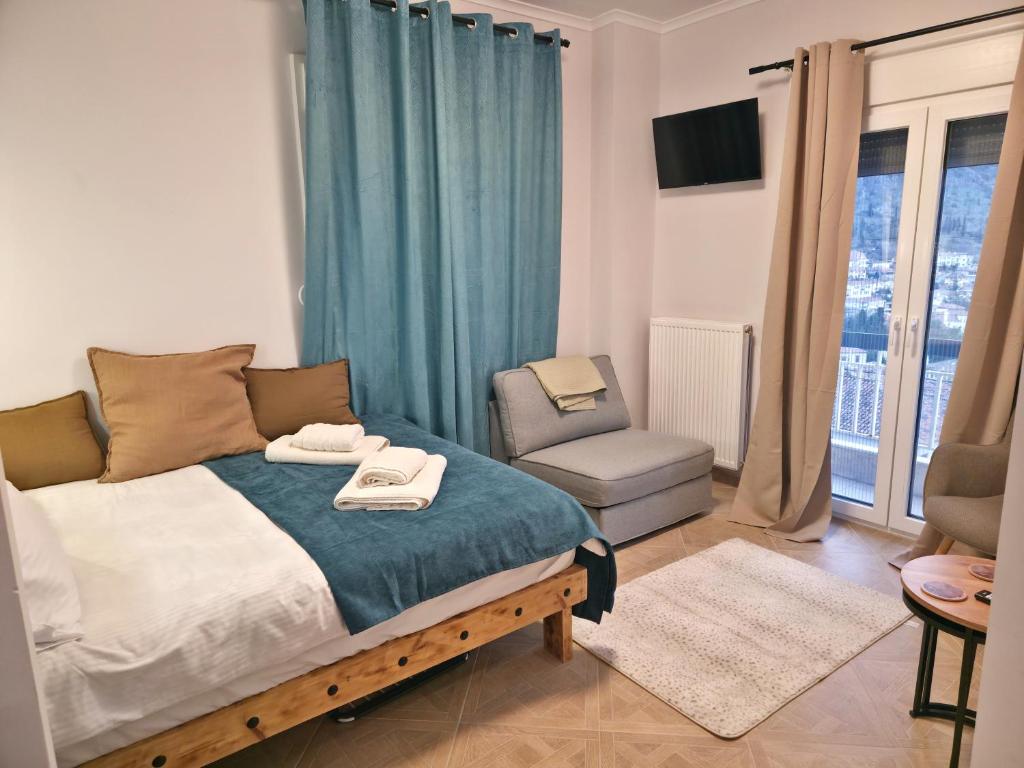 a bedroom with a bed and a chair and a window at Riana Dlx Studio in Kastoria