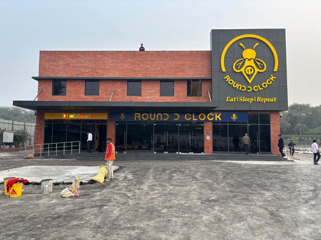 a building with a round clock sign on it at Round D Clock, IGI Airport in New Delhi